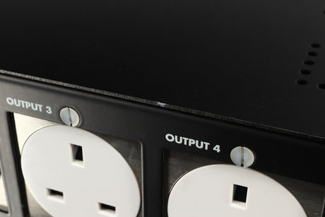 Close up of a used Isotek Nova Mains Conditioner in a black finish showing small nick on fascia