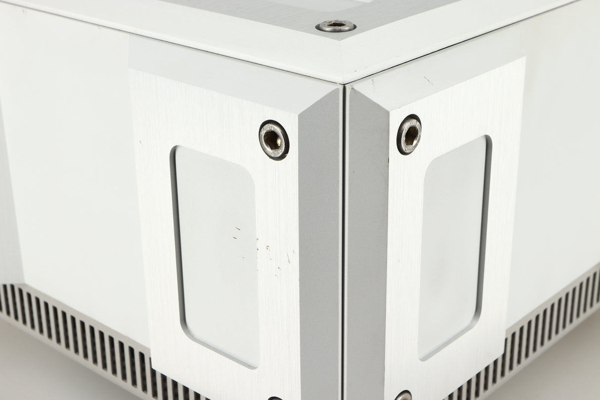 Close up of a used Isotek Titan Mains Conditioner in a silver finish showing some scratching