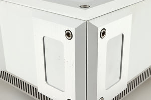 Close up of a used Isotek Titan Mains Conditioner in a silver finish showing some scratching