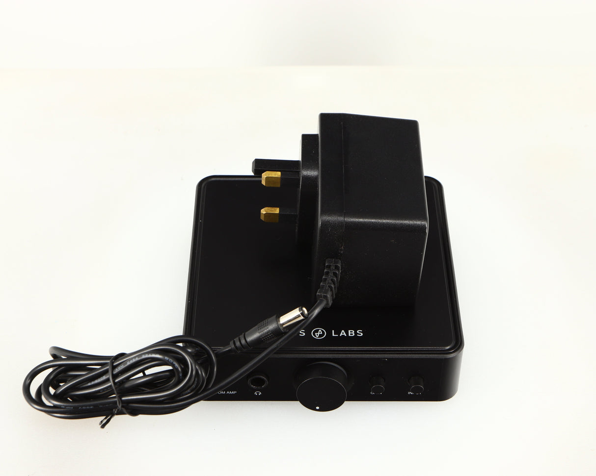 Top of a used JDS Labs Atom Headphone Amplifier in a black finish showing PSU