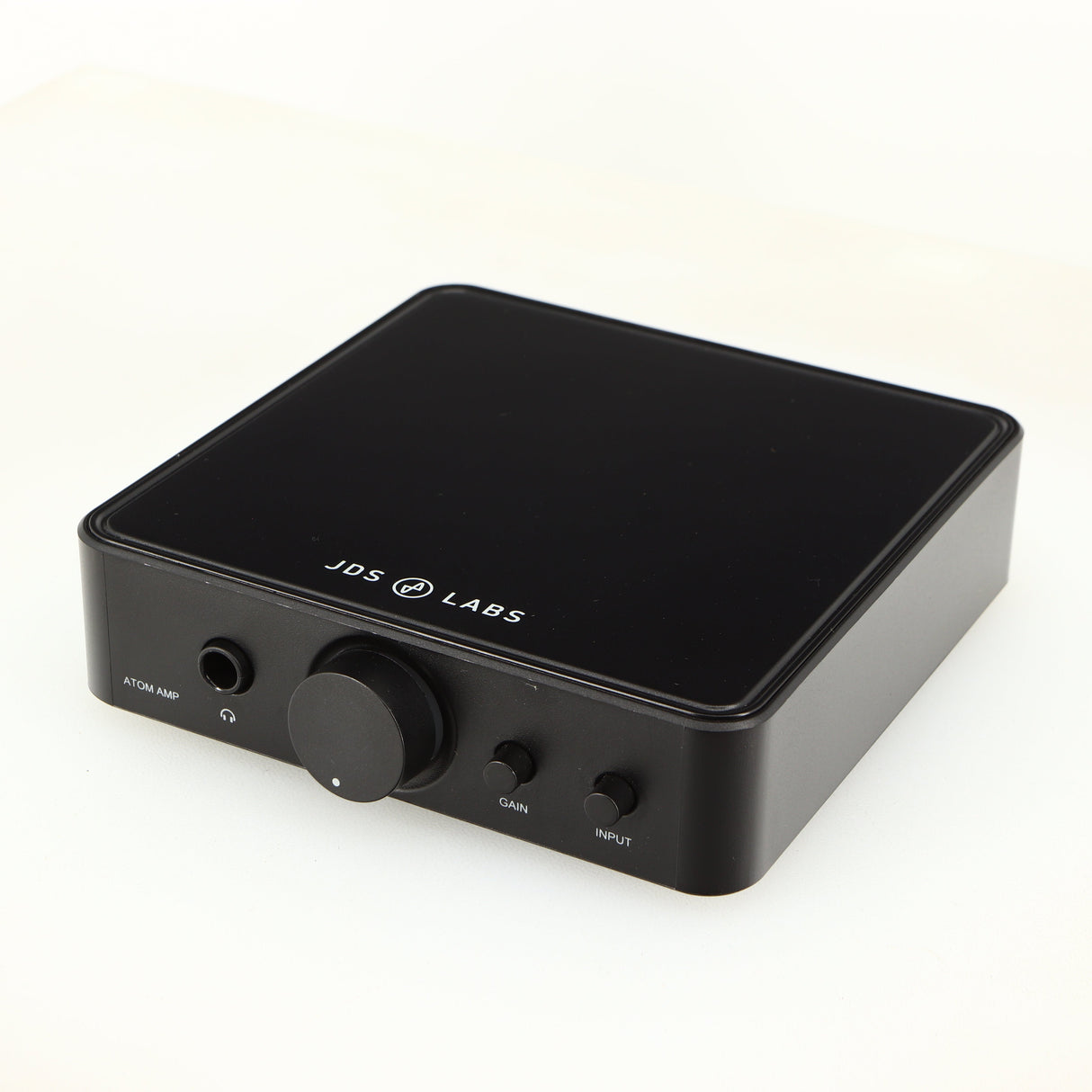 Close up of a used JDS Labs Atom Headphone Amplifier in a black finish showing fascia