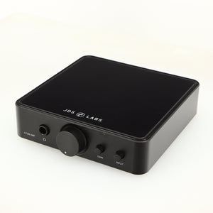 Close up of a used JDS Labs Atom Headphone Amplifier in a black finish showing fascia