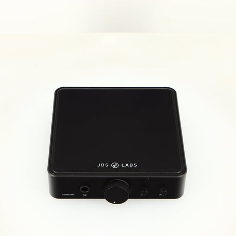 Top of a used JDS Labs Atom Headphone Amplifier in a black finish