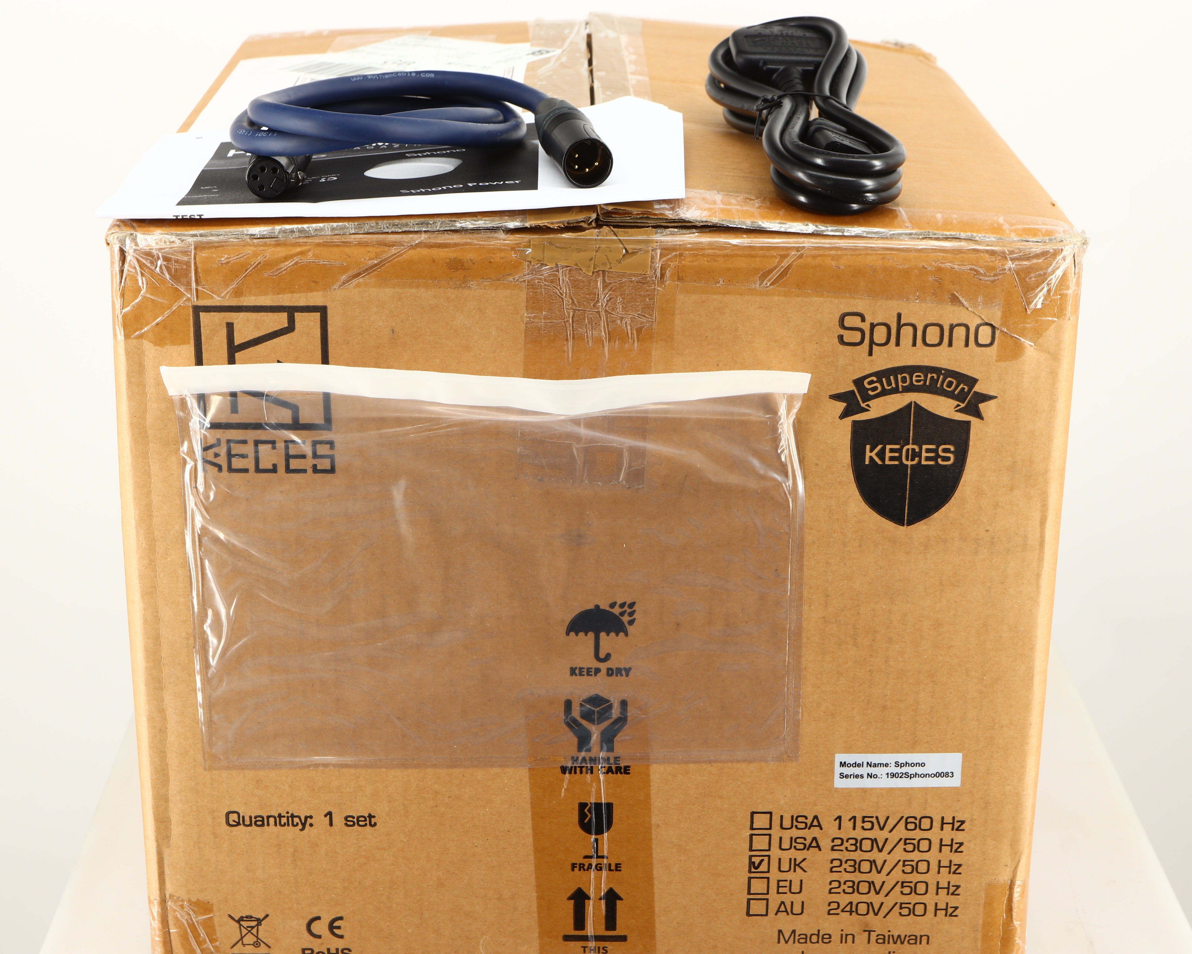Box for a used Keces Sphono Phonostage in a black finish showing Mains Cable, XLR Cable and Manual