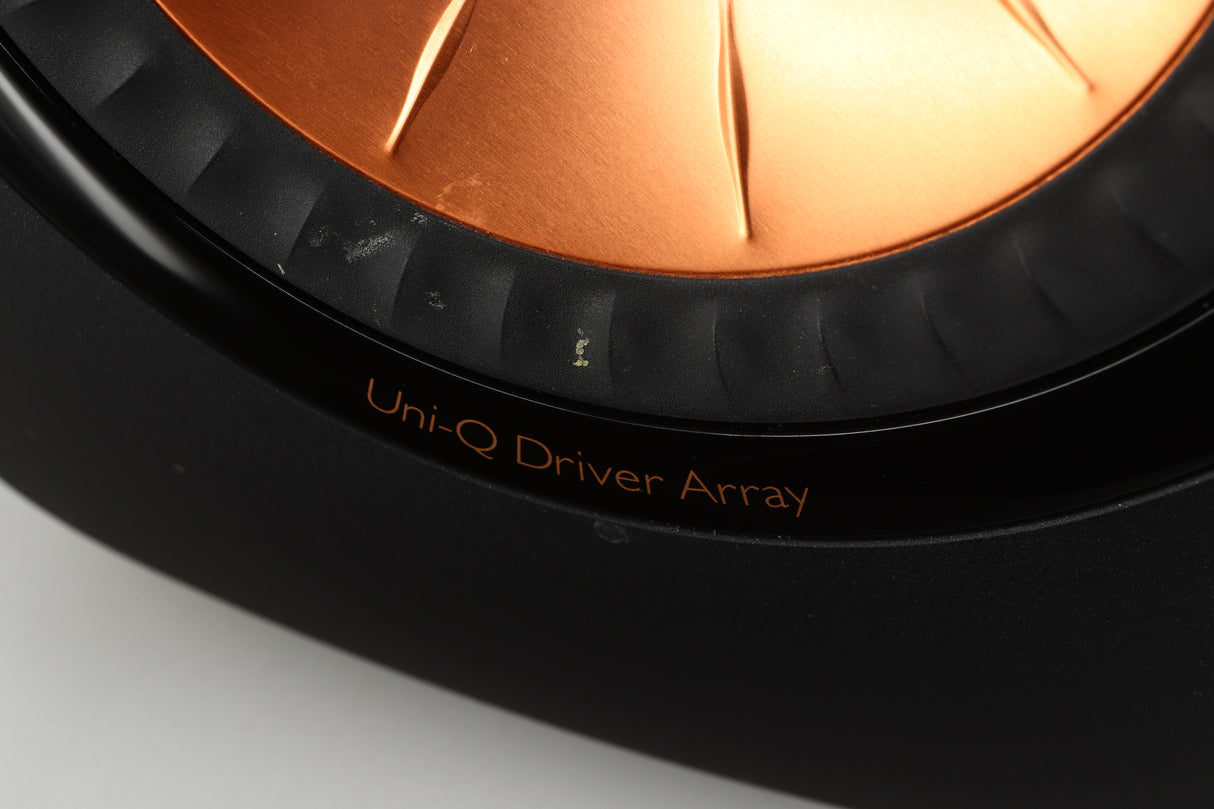  Close up of a used KEF LS50 Standmount Speaker in a black gloss finish showing some marks on the driver