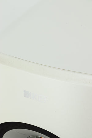 Close up of a used KEF LSX Standmount Speaker W/ Stand in a white finish showing some wear on the front top edge
