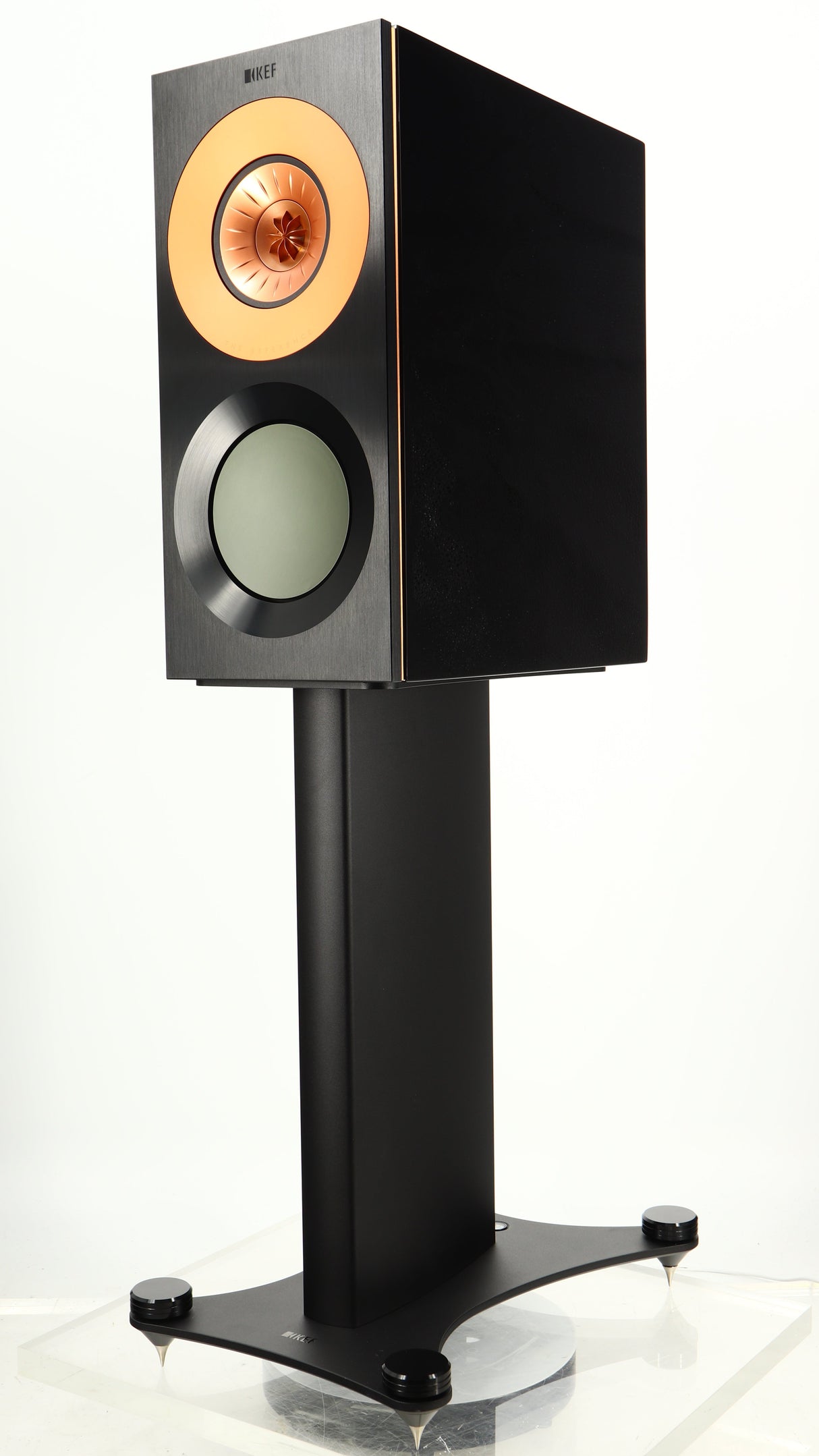 Front right corner of a used KEF Reference 1 Standmount Speaker W/ Stand in a copper black aluminium finish