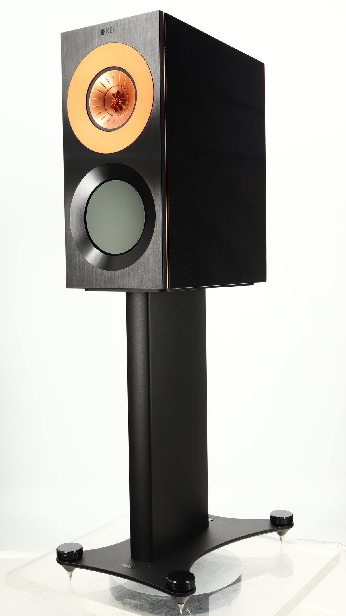 Front right corner of a used KEF Reference 1 Standmount Speaker W/ Stand in a copper black aluminium finish