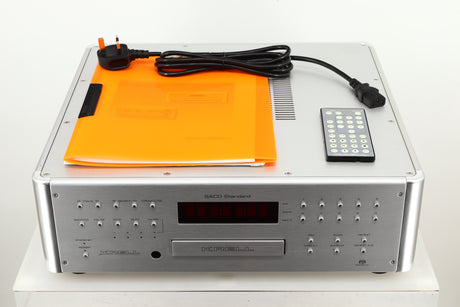 View of a used Krell SACD Standard CD Player in Silver finish showing manual, mains cable, and remote
