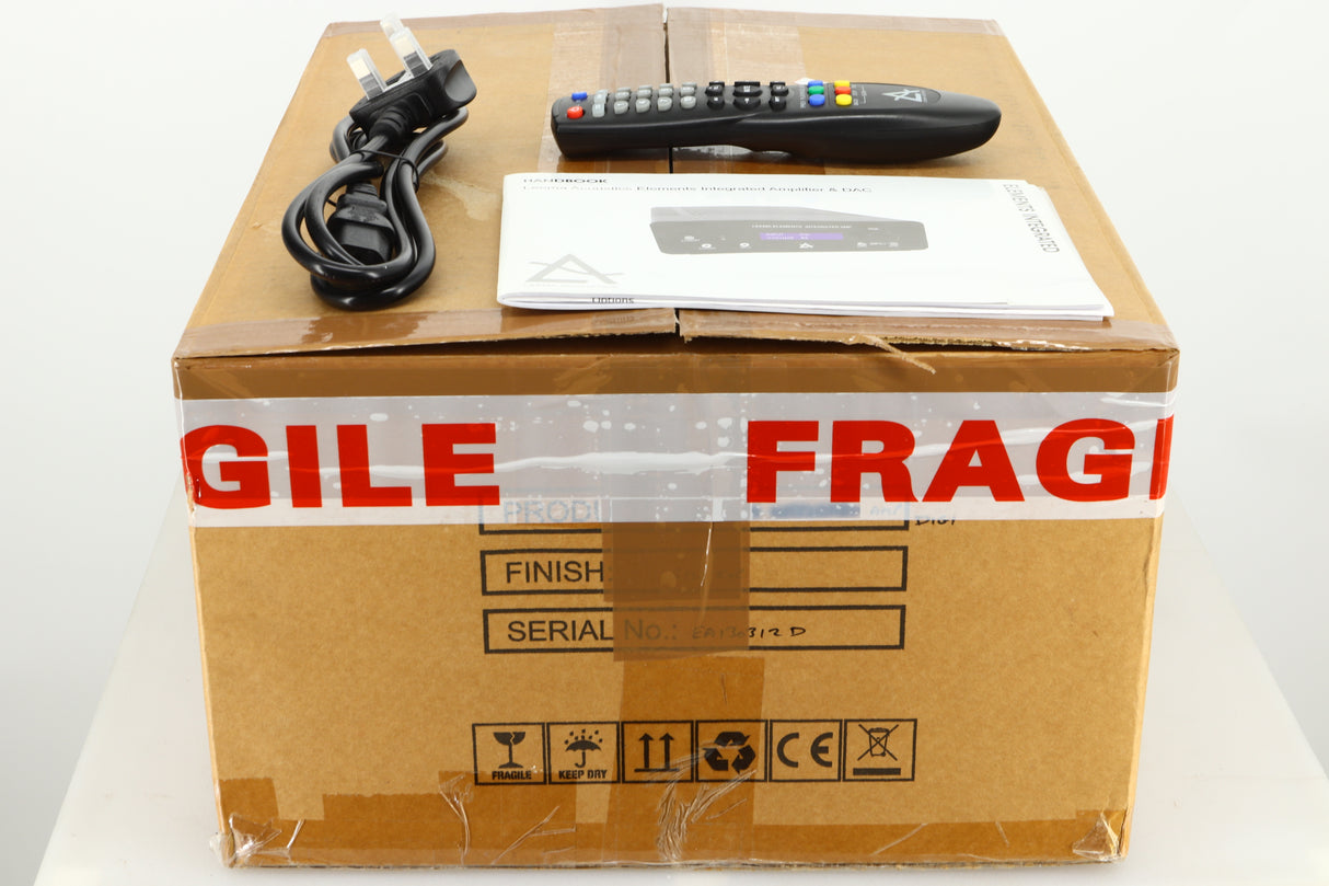 Box of a used Leema Acoustics Elements Integrated Amplifier in silver finish showing mains cable, manual, and remote 