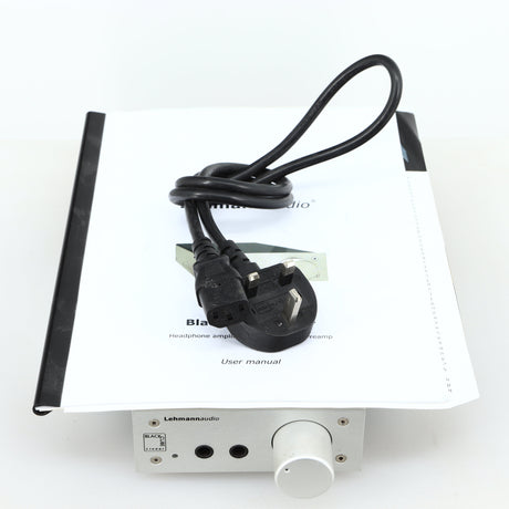 top of a used Lehmann Black Cube Linear Headphone Amplifier in a silver finish showing Mains Cable and Manual