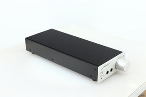 Front left corner of a used Lehmann Black Cube Linear Headphone Amplifier in a silver finish