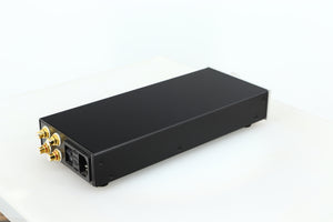 Rear left corner of a used Lehmann Black Cube Linear Headphone Amplifier in a silver finish