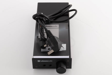 Top of a used Lehmann Linear Headphone Amplifier in a Black finish showing Manual and Mains Cable