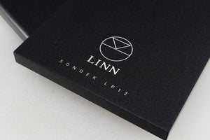 Close up of a used Linn Kore For Ekos LP12 Sub Chassis in a black finish showing logo