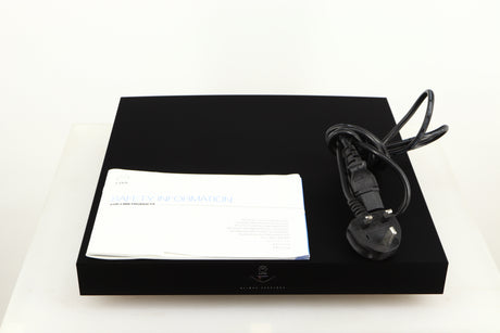 Top of a used Linn Klimax Exaktbox W/ Organic DAC in a black finish showing Mains Cable and Manual