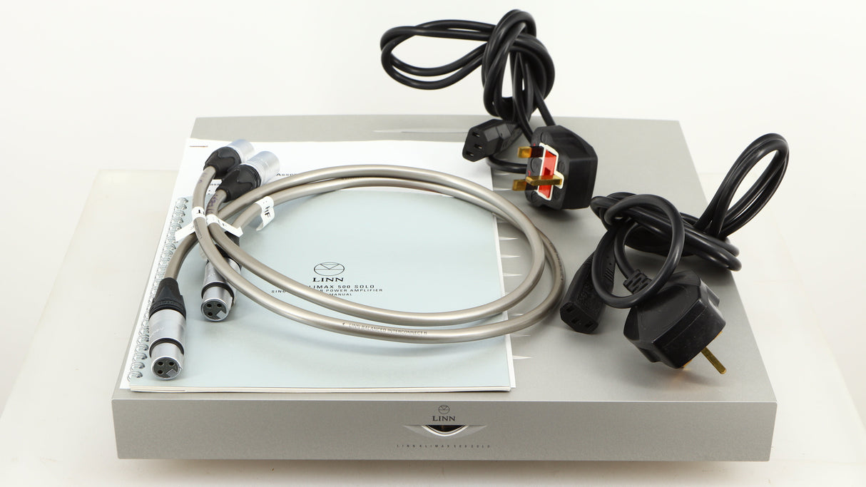 Top of a used Linn Klimax Solo 500 Power Amplifier in a silver finish showing Manual, XLR Interconnect Cable and 2x Mains Cables