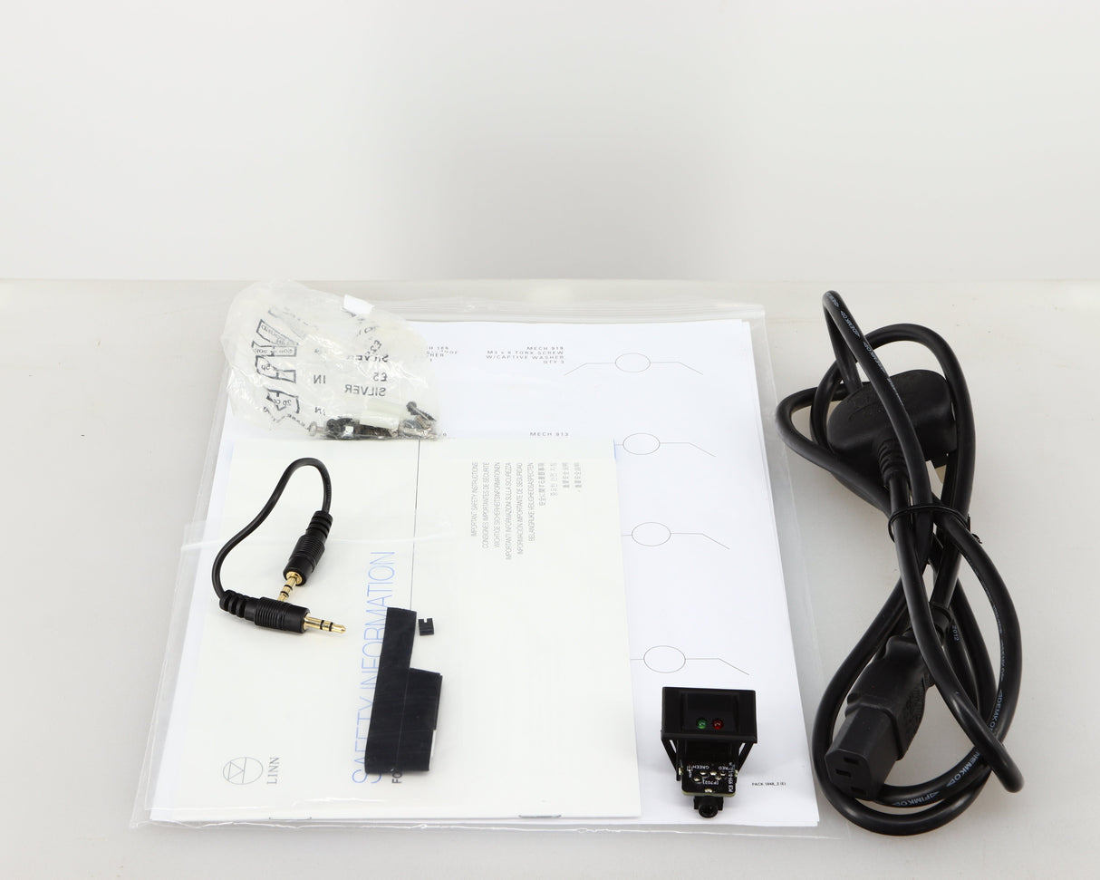 Accessories for a used Linn Lingo 4 Turntable Power Supply in a black finish showing Felt Strips, Mains Cable, Switch, AUX Cable, Screws and Manual