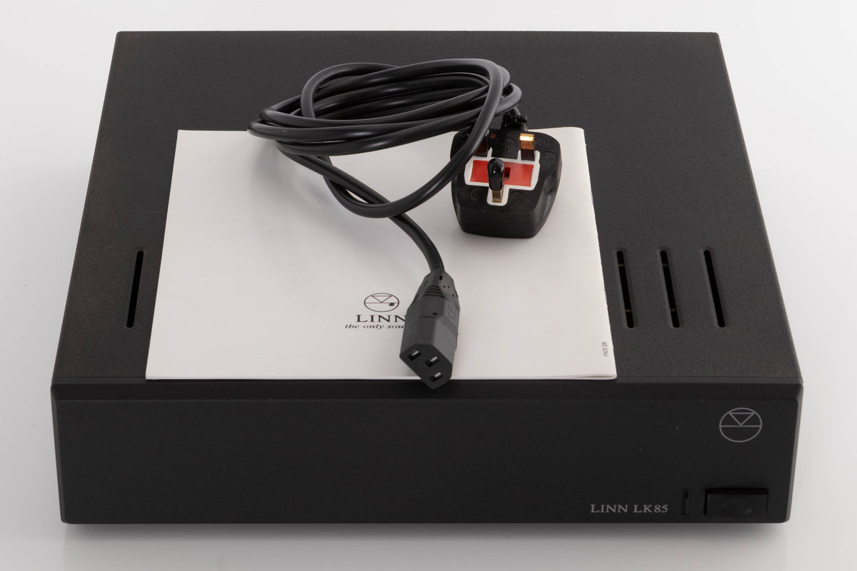 Top of a used Linn LK85 Power Amplifier in a Black finish showing Mains Cable and Manual
