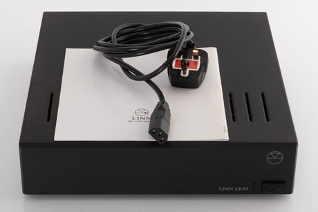 Top of a used Linn LK85 Power Amplifier in a Black finish showing Mains Cable and Manual