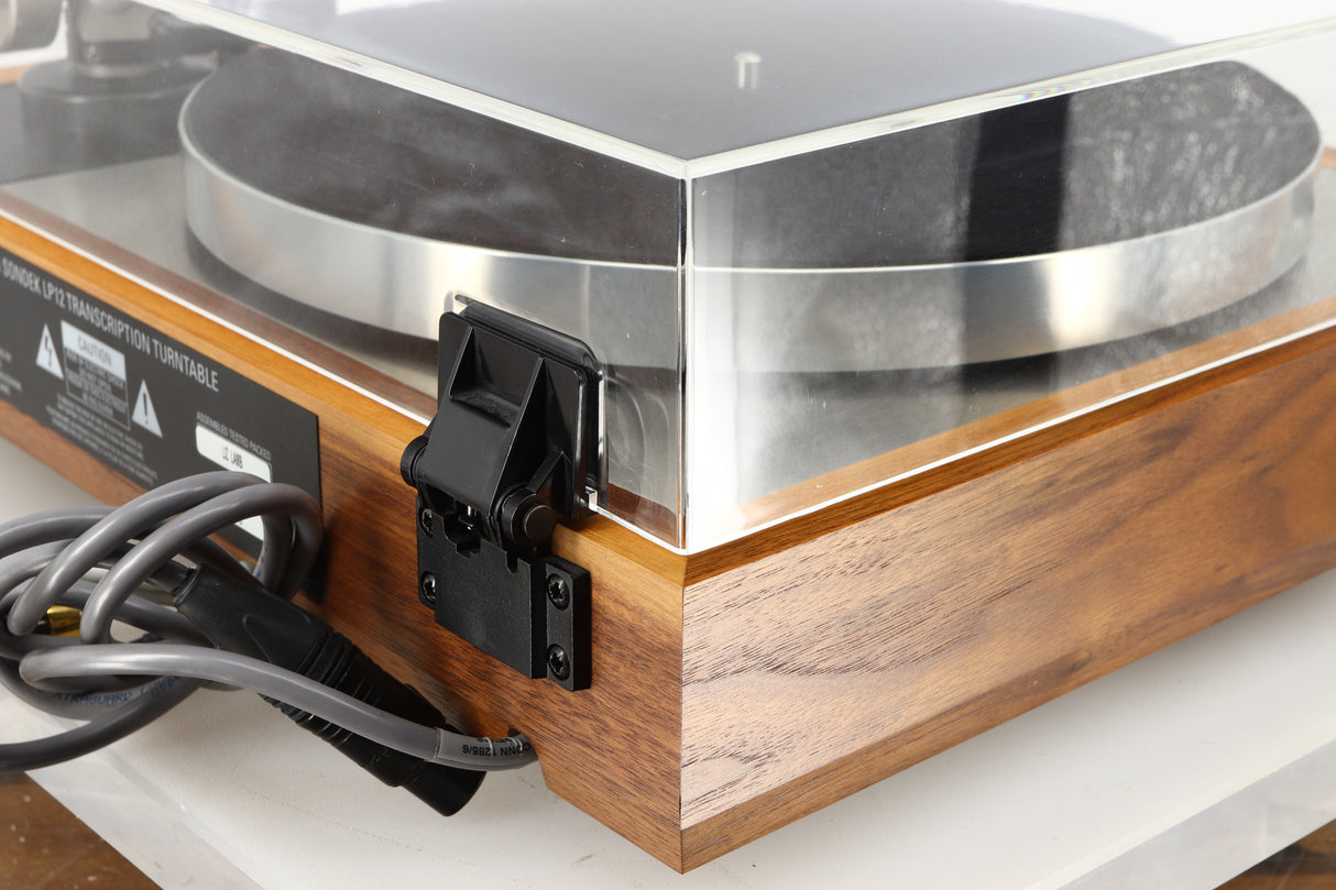Rear left corner of a used Linn LP12 Akurate Turntable / Ekos SE Tonearm / Krystal Cartridge in a walnut finish