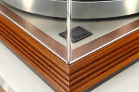 Close up of a used Linn LP12 / Ittok Tonearm / Adikt Cartridge in an afromosia finish showing small scratch on lid
