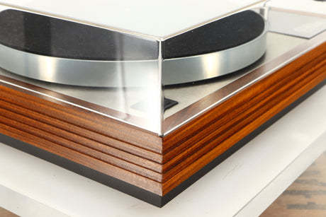 Front left corner of a used Linn LP12 / Ittok Tonearm / Adikt Cartridge in an afromosia finish
