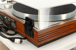 Rear left corner of a used Linn LP12 / Ittok Tonearm / Adikt Cartridge in an afromosia finish