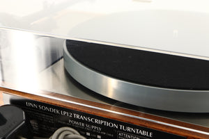 Close up of a used Linn LP12 Turntable / Akito Tonearm / Grado Prestige Blue Cartridge in an afromosia finish showing scratching on lid