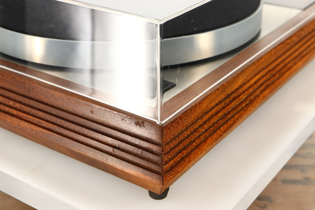 Front left corner of a used Linn LP12 Turntable / Akito Tonearm / Grado Prestige Blue Cartridge in an afromosia finish