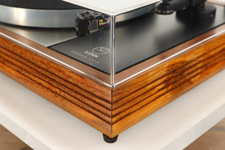 Front right corner of a used Linn LP12 Turntable / Akito Tonearm / Grado Prestige Blue Cartridge in an afromosia finish
