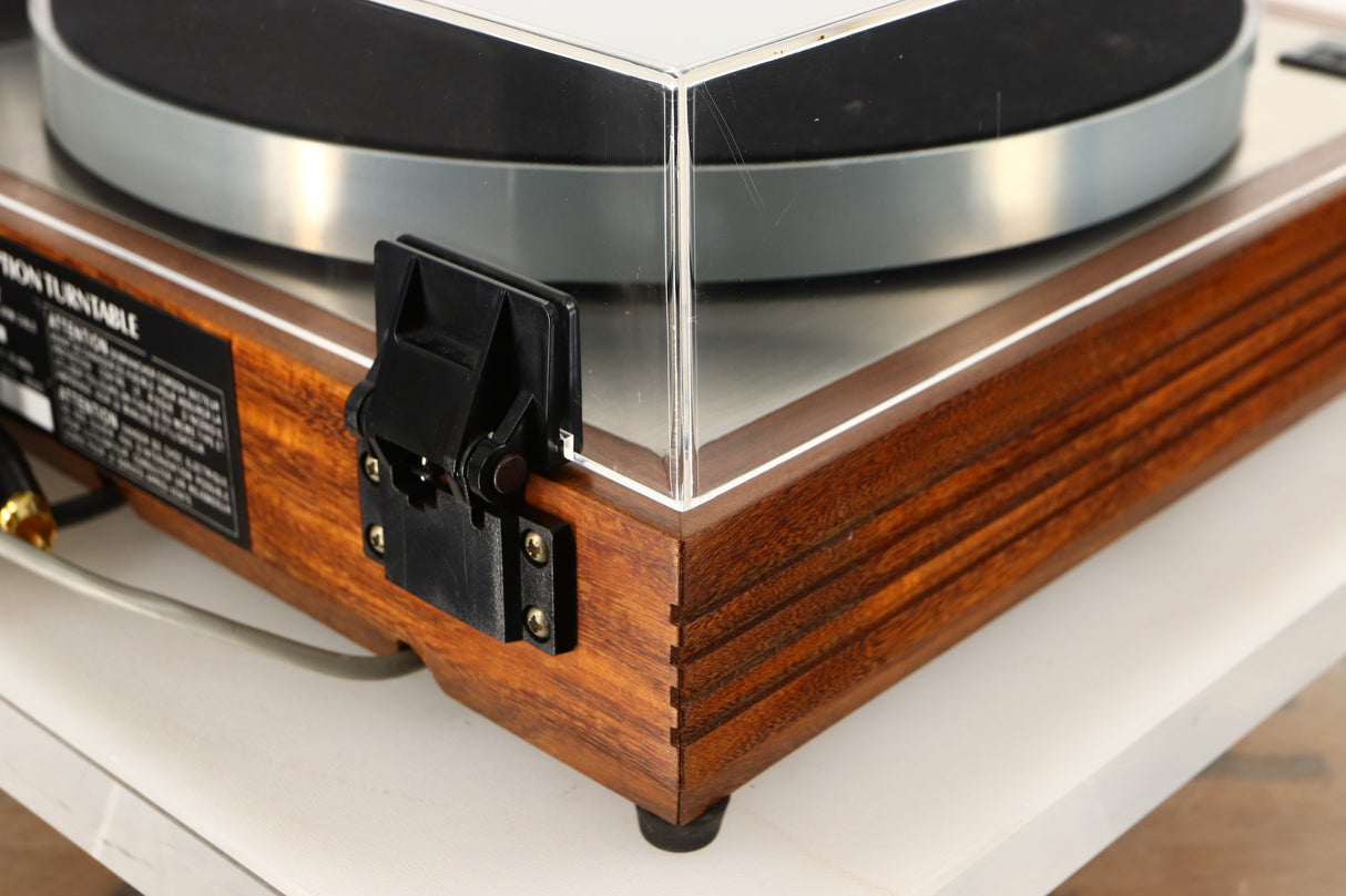 Rear left corner of a used Linn LP12 Turntable / Akito Tonearm / Grado Prestige Blue Cartridge in an afromosia finish