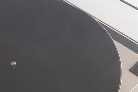 Close up of a used Linn LP12 Turntable / Basik Plus Tonearm / K-9 Cartridge in a Black Ash finish showing scratching on lid