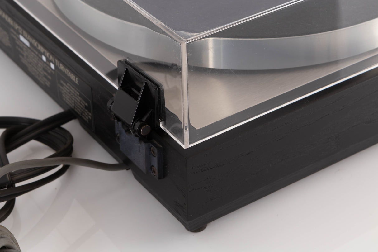 Rear left corner corner of a used Linn LP12 Turntable / Basik Plus Tonearm / K-9 Cartridge in a Black Ash finish