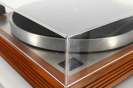 Close up of a used Linn LP12 Turntable / Ittok Tonearm / Hercules Power Supply in a afromosia finish showing scratching on the front of the lid