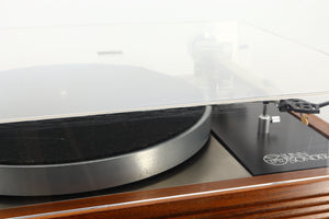 Close up of a used Linn LP12 Turntable / Ittok Tonearm / Hercules Power Supply in a afromosia finish showing scratching on the front of the lid