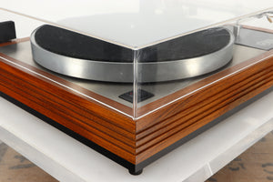 Front left corner of a used Linn LP12 Turntable / Ittok Tonearm / Hercules Power Supply in a afromosia finish