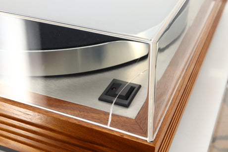 Close up view of a used Linn LP12 Turntable in Afromosia finish fitted with a Valhalla power supply board, and an Ekos tonearm showing a crack on the left side of the lid