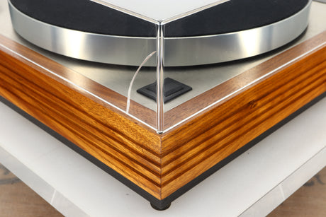 Front left corner view of a used Linn LP12 Turntable in Afromosia finish fitted with a Valhalla power supply board, and an Ekos tonearm 
