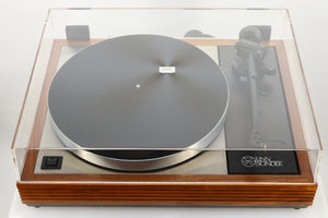 view of a used Linn LP12 Turntable in Afromosia finish fitted with a Valhalla power supply board, and an Ekos tonearm showing the lid