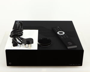 Top of a used Linn Majik DSM5 Network Music System in a black finish showing Mains Cable, Manual and Remote