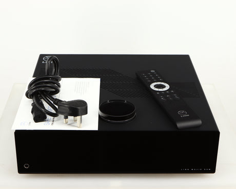 Top of a used Linn Majik DSM5 Network Music System in a black finish showing Mains Cable, Manual and Remote