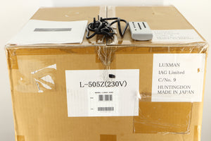 Box of a used Luxman 505z Integrated Amplifier with mains cable, manual, and remote