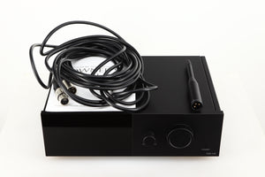 Top of a used Lyngdorf TDAI-1120 Integrated Streaming System in a black finish showing Manual, Set-Up Mic and XLR Cable