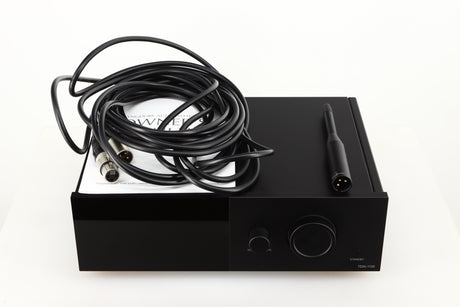 Top of a used Lyngdorf TDAI-1120 Integrated Streaming System in a black finish showing Manual, Set-Up Mic and XLR Cable