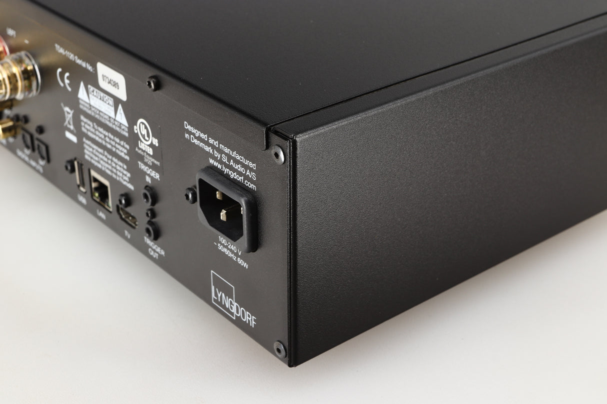 Rear left corner of a used Lyngdorf TDAI-1120 Integrated Streaming System in a black finish