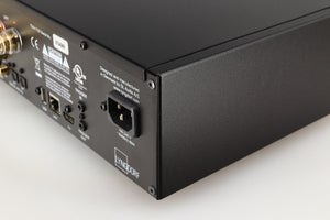 Rear left corner of a used Lyngdorf TDAI-1120 Integrated Streaming System in a black finish