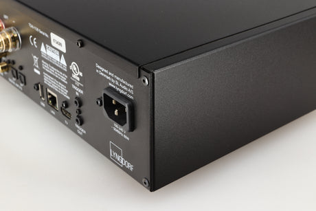 Rear left corner of a used Lyngdorf TDAI-1120 Integrated Streaming System in a black finish