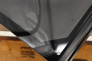 Close up of a used Mana Sound Turntable Wall Shelf in a black finish showing scratching on glass