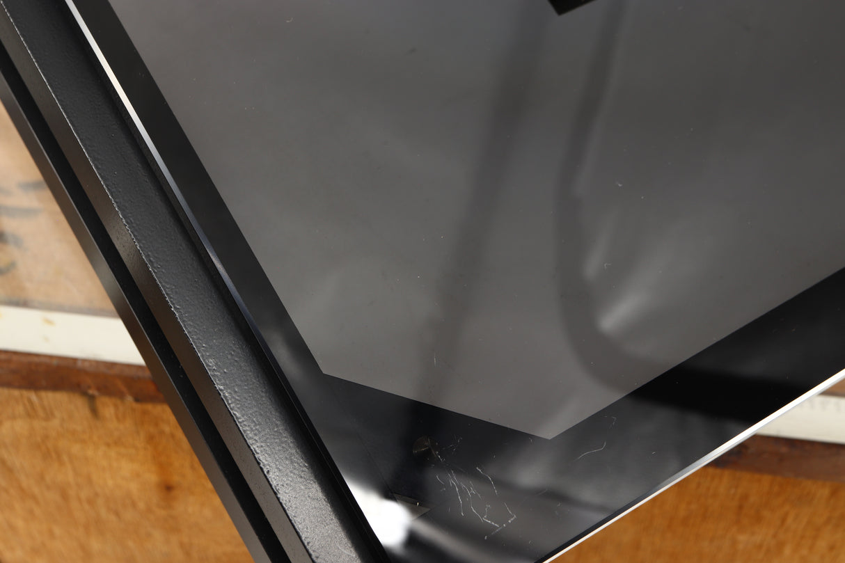 Close up of a used Mana Sound Turntable Wall Shelf in a black finish showing scratching on glass